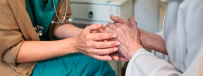 nurse holding hands of elderly woman care industry
